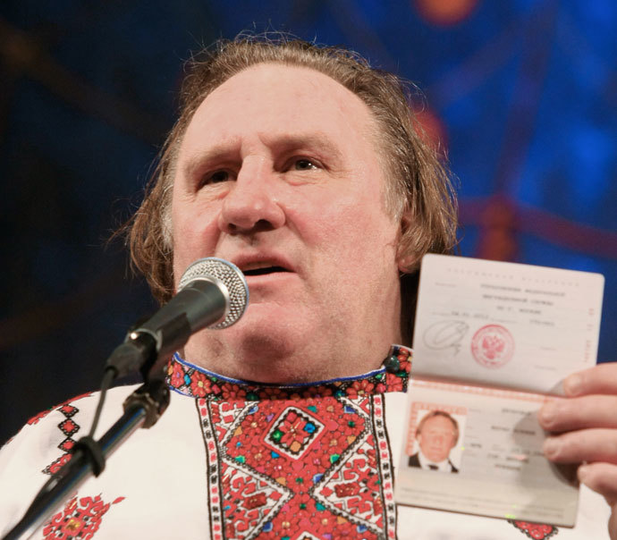French actor Gerard Depardieu, who was granted Russian citizenship, showing his Russian passport while wearing a Mordovian national shirt at the Theater of Opera and Ballet in Saransk.(RIA Novosti / Julia Chestnova)