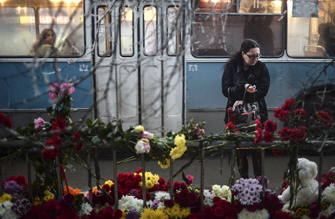 A woman reacts while standing near flowers placed at the site of an explosion on a trolleybus in Volgograd December 31, 2013. (Reuters / Sergei Karpov)