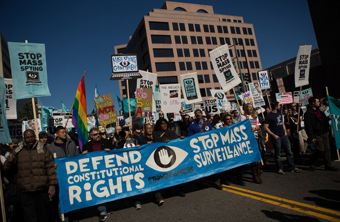 Protesters march through downtown Washington D.C. during the Stop Watching Us Rally protesting surveillance by the U.S. National Security Agency, on October 26, 2013, in front of the U.S. Capitol building in Washington, D.C. (AFP Photo / Allison Shelley)