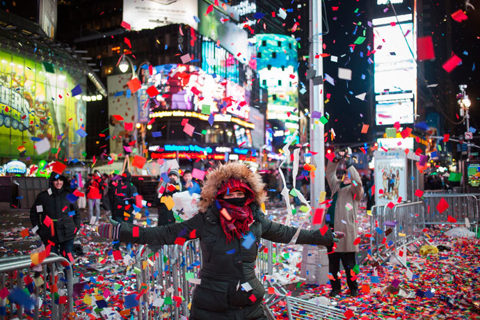 Valentina Guazzolini, of Ravenna, Italy, plays in confetti which was scattered by a gust of wind into the air after New Year celebrations in Times Square, Midtown, New York January 1, 2014.(Reuters / Adrees Latif)