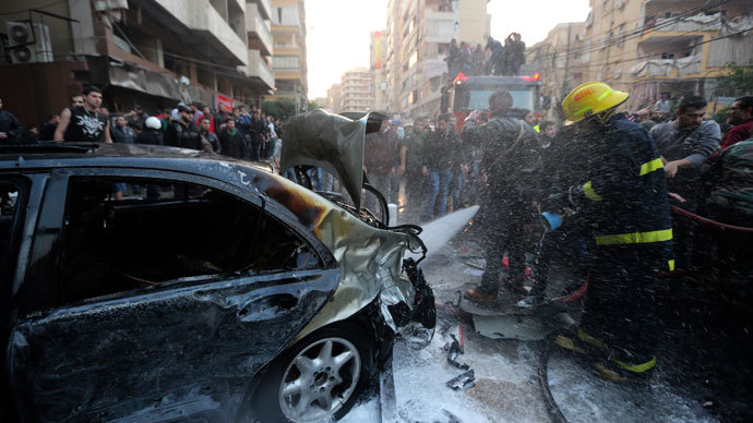 A firefighter extinguishes a fire on a car at the site of an explosion in Beirut's southern suburbs January 2, 2014.(Reuters / Hasan Shaaban)