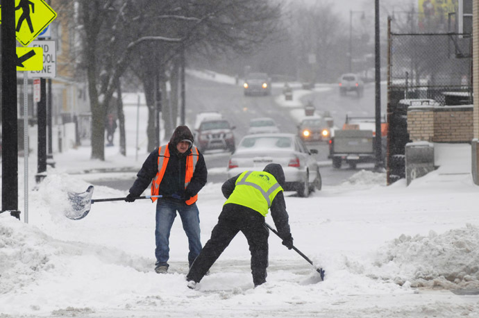 City workers shovel snow from in front of the Orient Heights T Station on Bennington Street January 2, 2014 in East Boston, Massachusetts. (Darren McCollester/Getty Images/AFP)