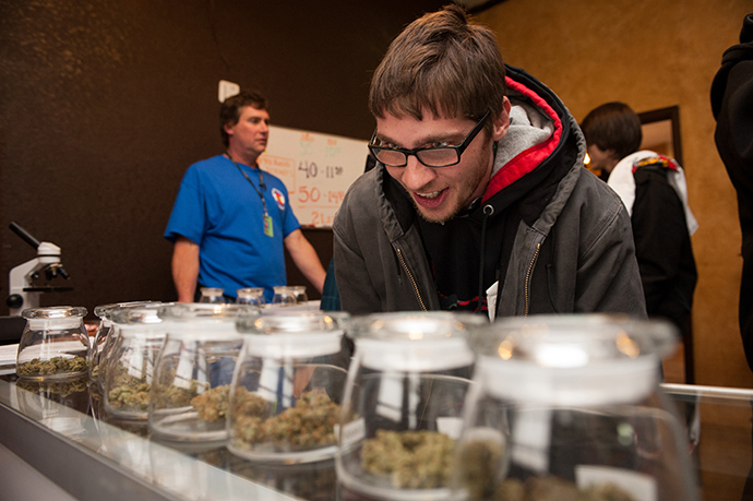 Tyler Williams of Blanchester, Ohio selects marijuana strains to purchase at the 3-D Denver Discrete Dispensary on January 1, 2014 in Denver, Colorado. (AFP Photo / Getty Images / Theo Stroomer)