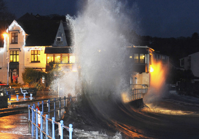 Waves crash over the promenade at hightide in Saundersfoot, in west Wales January 3, 2014. (Reuters/Rebecca Naden)