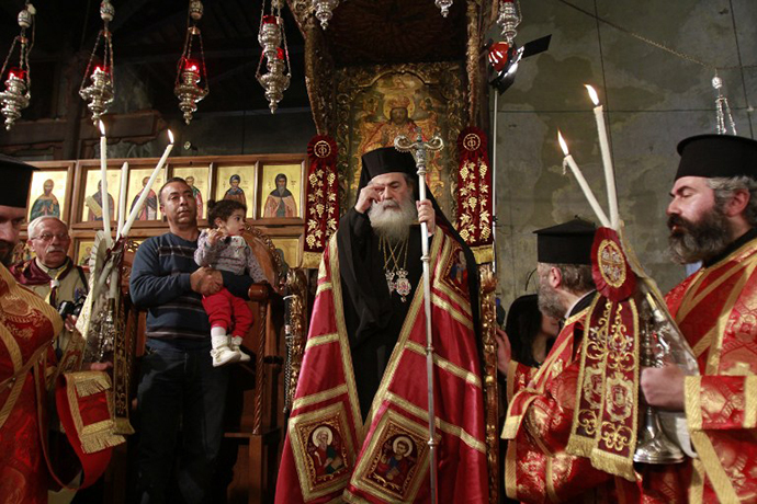 Greek Orthodox Patriarch of Jerusalem Theophilos III leads the service at the Church of the Nativity in the biblical West Bank town of Bethlehem as Orthodox Christmas celebrations kicked off on January 6, 2014, in the traditional birthplace of Jesus Christ. (AFP Photo / Musa Al-Shaer)
