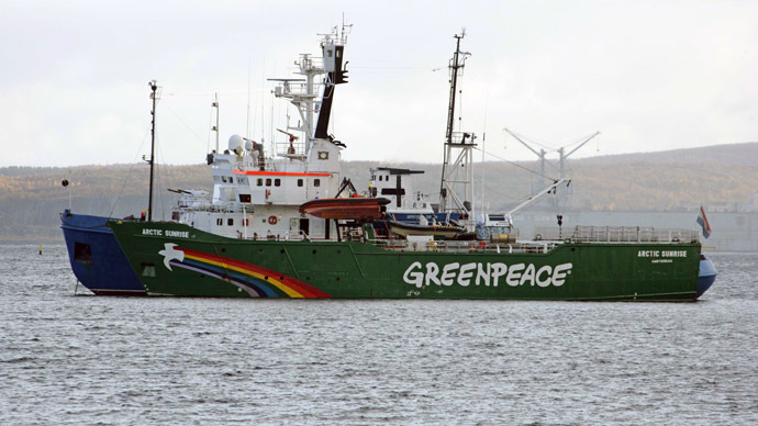A handout photo provided by Greenpeace International shows the Greenpeace ship, Arctic Sunrise, being towed on September 24, 2013 into the Russian port of Murmansk by a Russian Coast Guard vessel. (AFP/Greenpeace) 