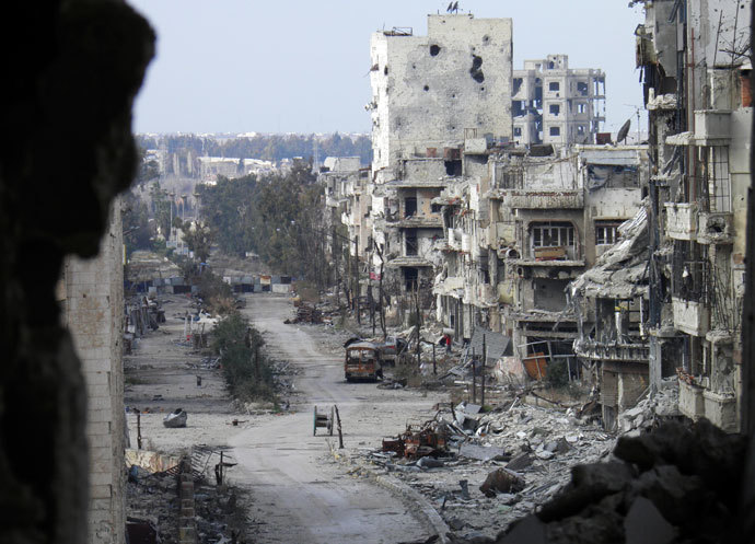 Damaged buildings line a deserted street in the besieged area of Homs.(Reuters / Thaer Al Khalidiya)
