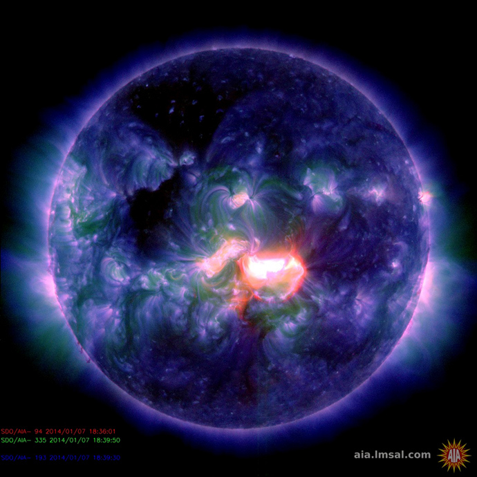 This January 7, 2014 handout image captured by NASA's Solar Dynamics Observatory shows a false-color composite image from a blast of activity originating from an active sunspot region at the center of the sun's disk (AFP Photo)