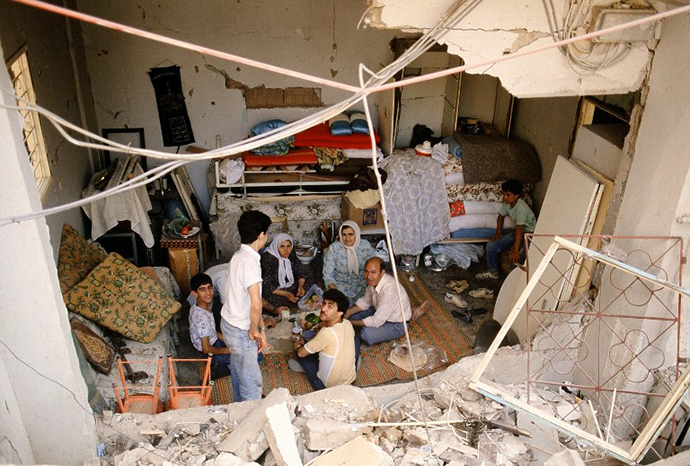 Palestinian refugee families who fled the fighting between Palestinian guerrillas and Amal Shi'ite militia in Sabra and Shatila Palestinian refugee camps in the southern West Beirut are sheltered 27 May 1985 in an underground parking of Moussaitbe area in West Beirut, protected by Druze Socialist Progressist Party. (AFP Photo / Joel Robine)