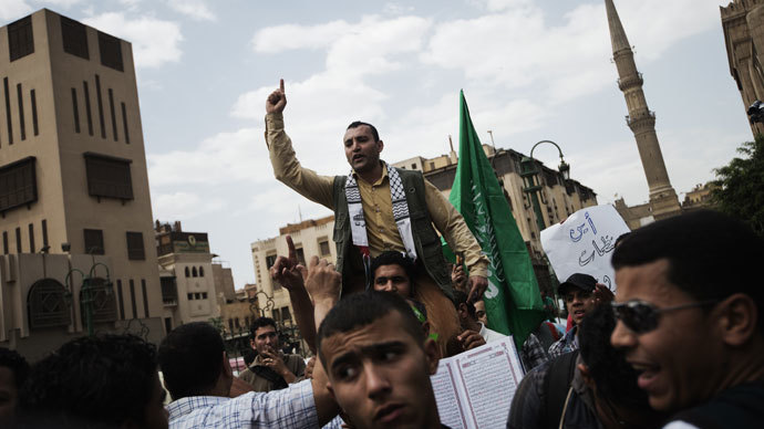 An Egyptian man shouts religious slogans near the green Hamas movement flag during a demonstration in support of the Palestinian people and of Muslims around the world, on May 10, 2013 front of the Al-Ahzar mosque in Cairo.(AFP Photo / Gianluigi Guercia)