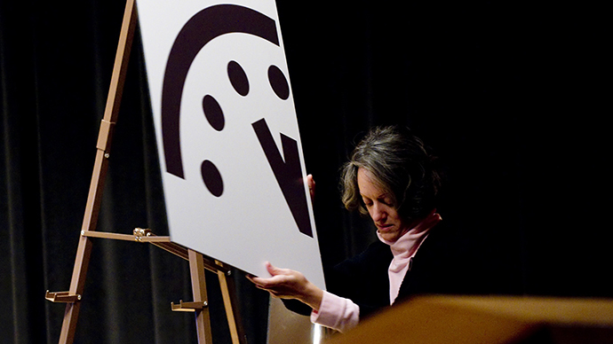 A depiction of the Doomsday Clock is removed following an announcement by the Bulletin of Atomic Scientists (BAS) announcing that it has moved the hands to five minutes to midnight, up one minute from two years ago, at the American Association for the Advancement in Washington, DC (AFP Photo / Saul Loeb)