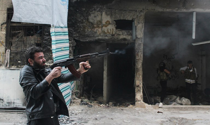 A rebel fighter from the Free Syrian Army fires his weapon during fighting against government forces in the Salah al-Din neighbourhood of the northern Syrian city of Aleppo. (AFP Photo / Mahmud Al-Halabi)