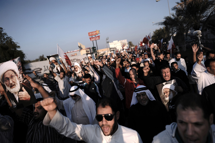 Bahraini protestors shout anti-regime slogans during an anti-government protest in the village of Shakhora, west of Manama, on January 3, 2014. (AFP Photo / Mohammed Al-Shaikh)