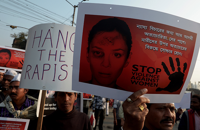 Indian Aam Admi Party (AAP) activists hold posters during a rally as they protest against the gangrape and murder of a teenager in Kolkata on January 5, 2014. (AFP Photo / Dibyangshu Sarkar)