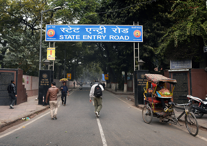 Unidentified men walk on January 15, 2013 near the entrance of a street that leads to a park where a Danish tourist visiting India was allegedly raped in New Delhi on January 14. (AFP Photo / Sajjad Hussain)