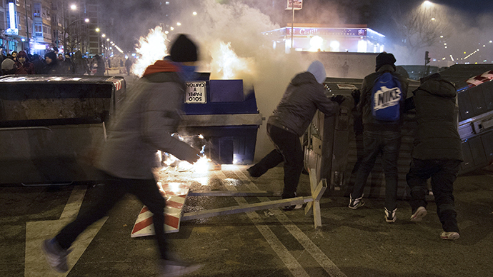 Protesters stand near a burning garbage container during a demonstration against construction plans to turn the Vitoria main avenue into a boulevard in Burgos January 13, 2014. (Reuters / Ricardo Ordonez)