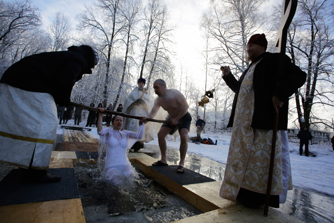 A Russian Orthodox Christian takes a dip in an icy pond during Orthodox Epiphany celebrations in the village of Strelna outside St. Petersburg January 19, 2014. (Reuters / Maxim Zmeyev)