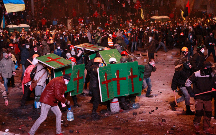 Pro-European integration protesters hide behind shields during clashes with Ukranian riot police in Kiev January 19, 2014. (Reuters / Gleb Garanich)