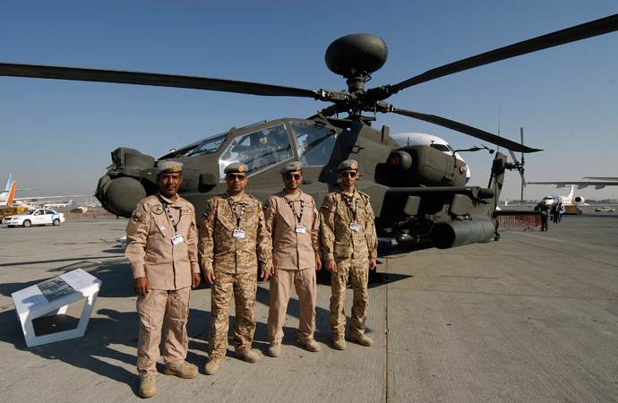 United Arab Emirates army pilots pose in front of the AH-64D Apache helicopter (Reuters / Nikhil Monteiro)