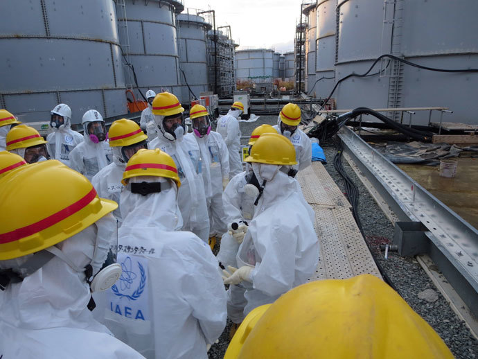 This handout picture taken by Tokyo Electric Power Co. (TEPCO) on November 27, 2013 shows review mission members of the International Atomic Energy Agency (IAEA), led by Juan Carlos Lentijo, inspecting a spent fuel pool at the crippled Tokyo Electric Power CO.(AFP Photo / TEPCO)