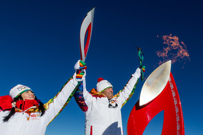  A handout picture taken during the Sochi 2014 Winter relay on October 25, 2013 and released by the Sochi 2014 Winter Olympics Organizing Committee, shows torchbearers carrying an Olympic torch at the Elbrus Mount in Russia's North Caucasus region. (AFP Photo/Sochi 2014 Winter Olympics Organizing Committee)