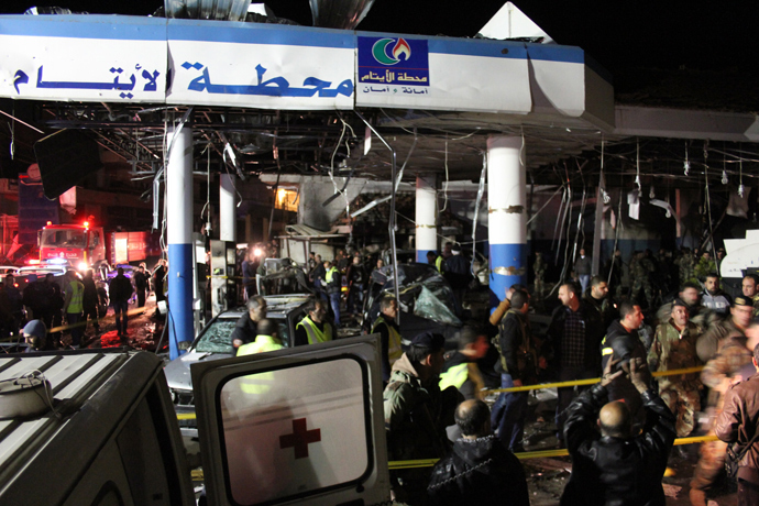 Lebanese emergency personnel are seen at the site of a car bomb explosion targeting a petrol station in eastern Lebanon's town of Hermel on February 1, 2014 (AFP Photo / STR)