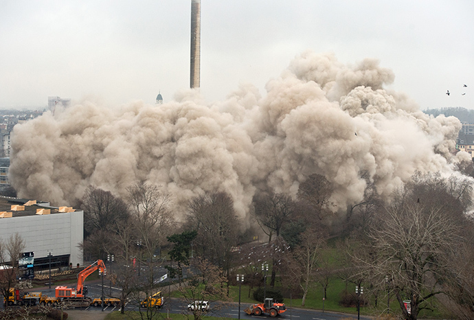 A giant dust cloud emerges during the blasting of a 116 meters building in Frankfurt am Main, western Germany, on February 2, 2014. (AFP Photo / Boris Roessler)