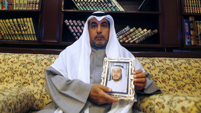 Khalid al-Odah, the father of Fawzi al-Odah, one of two Kuwaiti detainees still being held at Guantanamo Bay , holds his sonâs picture, at his home in the Qurtuba district of Kuwait City (AFP Photo)