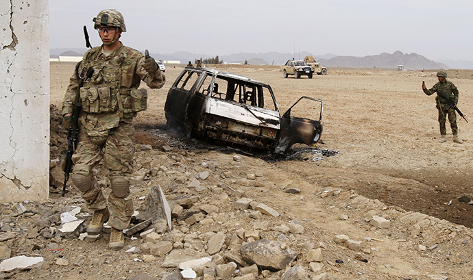 A U.S. soldier stands at the site of a suicide attack on a NATO base in Zhari, west of Kandahar province, January 20, 2014. (Reuters / Ahmad Nadeem)