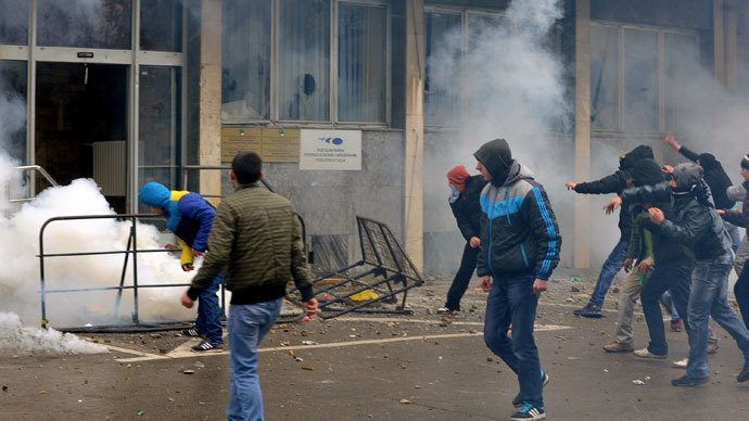 Protesters throw stones at a local government building in the northern Bosnian town of Tuzla, on February 6, 2014.(AFP Photo / Stringer)