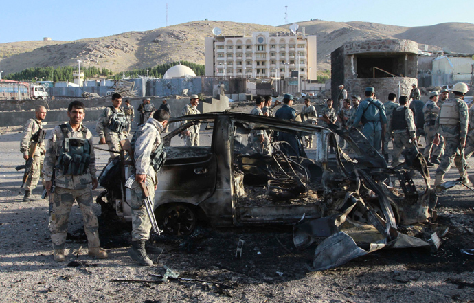 Afghan security forces inspect a damaged car, which was used during a suicide bomb attack, outside the U.S. consulate in Herat province September 13, 2013 (Reuters / Mohammad Shoib)