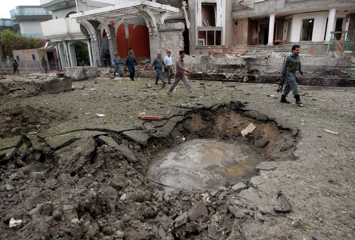 Afghan policemen walk near a crater at the site of a suicide attack at the Indian consulate in Jalalabad province August 3, 2013 (Reuters / Parwiz)