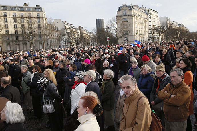 People gathered against feminist collective Femen on the Place Vauban in Paris, on February 8, 2014. (AFP Photo / Patrick Kovarick)