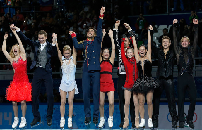 The Russian figure skating team celebrates its gold medal on the podium during the Figure Skating Team Flower Ceremony at the Iceberg Skating Palace during the Sochi Winter Olympics on February 9, 2014.(AFP Photo / Adrian Dennis)