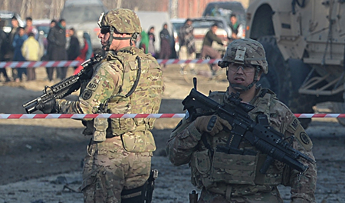 US soldiers, part of the NATO-led International Security Assistance Force (ISAF), stand guard at the site of a car bomb in the Pol-e-Charkhi area of Kabul on February 10, 2014. (AFP Photo / Shah Marai)