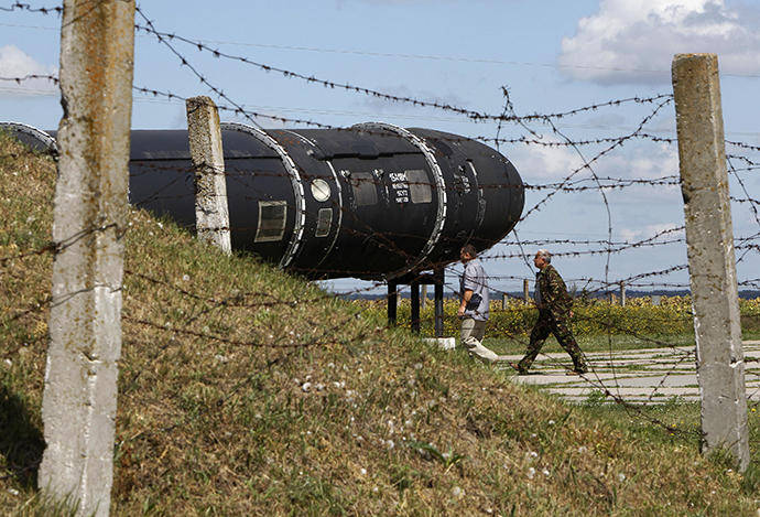 Visitors walk past an SS-18 SATAN intercontinental ballistic missile at the Strategic Missile Forces museum near Pervomaysk, some 300 km (186 miles) south of Kiev (Reuters / Gleb Garanich)