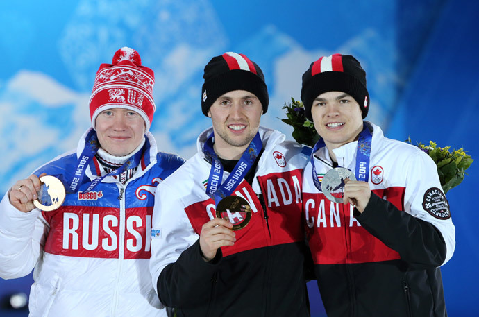 (From L) Russia's bronze medalist Alexandr Smyshlyaev, Canada's gold medalist Alex Bilodeau and Canada's silver medalist Mikael Kingsbury pose on the podium during the Men's Freestyle Skiing Moguls Medal Ceremony at the Sochi medals plaza during the Sochi Winter Olympics on February 11, 2014 (AFP Photo / Loic Venance)