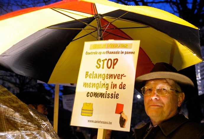 A protester holds up a sign during a demonstration against a new law authorizing euthanasia for children, in Brussels February 11, 2014. (Reuters / Laurent Dubrule)