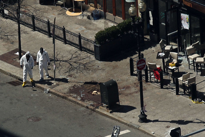 Investigators stand at the scene of twin bombings at the Boston Marathon on April 17, 2013 in Boston, Massachusetts. (Spencer Platt / Getty Images / AFP) 