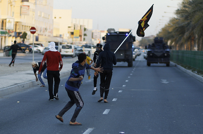 Anti-government protesters throw stones at riot police after the funeral procession for Asma Hussain, in the village of Jid Al Haj, west of Manama, February 12, 2014. (Reuters / Hamad I Mohammed)