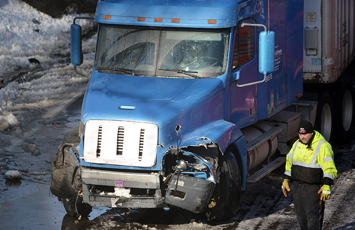 Rescue and fire personnel assist on the scene of a 100 car chain reaction pileup accident on the Pennsylvania Turnpike eastbound February 14, 2014 in Feasterville, Pennsylvania. (AFP Photo / William Thomas Cain)