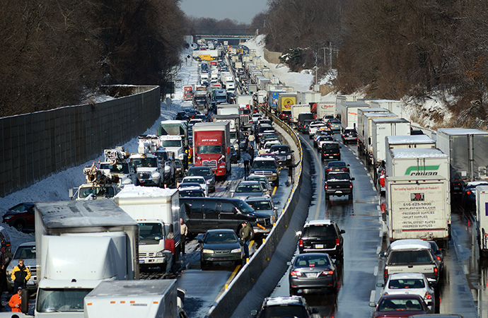 Rescue and fire personnel assist on the scene of a 100 car chain reaction pileup accident on the Pennsylvania Turnpike eastbound February 14, 2014 in Feasterville, Pennsylvania. (AFP Photo / William Thomas Cain)