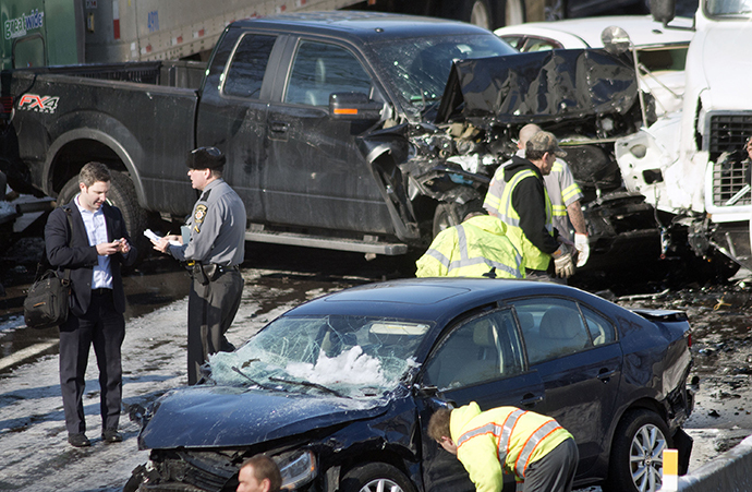 Rescue and fire personnel assist on the scene of a 100 car chain reaction pileup accident on the Pennsylvania Turnpike eastbound February 14, 2014 in Feasterville, Pennsylvania. (AFP Photo / William Thomas Cain)