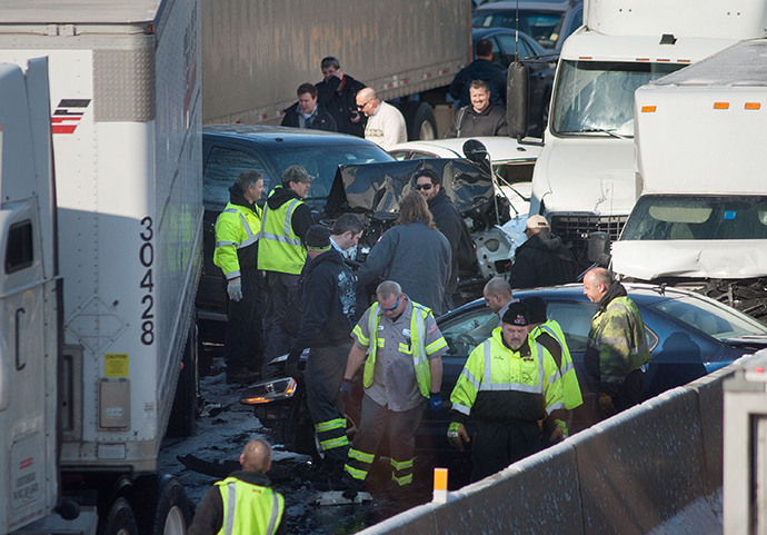 Rescue and fire personnel assist on the scene of a 100 car chain reaction pileup accident on the Pennsylvania Turnpike eastbound February 14, 2014 in Feasterville, Pennsylvania. (AFP Photo / William Thomas Cain)