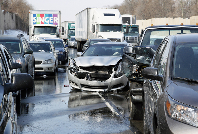 Smashed vehicles await assistance as dozens of flipped-over cars, jack-knifed tractor-trailers and vehicles skidded off the Pennsylvania Turnpike during the morning commute, shutting down the major thoroughfare near the Bensalem interchange in Pennsylvania, February 14, 2014. (Reuters / Tom Mihalek)