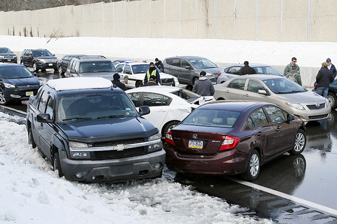 Drivers stand outside of their cars as traffic is backed up following a multi-car and truck accident during the morning commute, shutting down the major thoroughfare near the Bensalem interchange in Pennsylvania, February 14, 2014. (Reuters / Tom Mihalek)