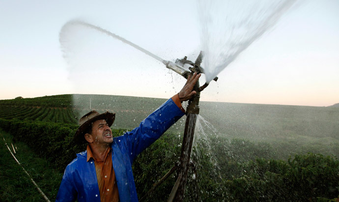 Brazilian coffee producer Marcio Diogo adjusts an irrigation system in his farm in Santo Antonio do Jardim (Reuters / Paulo Whitaker)