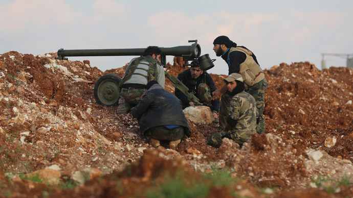 Rebel fighters prepare to fire an anti-tank cannon towards the government forces Al-Samman checkpoint on a road leading to Idlib near the Syrian city of Hama, on February 17, 2014. (AFP Photo / Abu Hadi Al-Hamwi) 