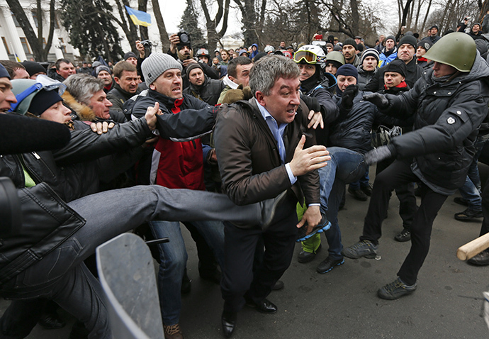Anti-government protesters attack a deputy of the Party of Regions Vitaly Grushevsky (C) outside the Ukrainian Parliament building in Kiev February 22, 2014. (Reuters / Vasily Fedosenko)