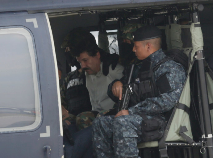 Joaquin "Shorty" Guzman (C) is seen sitting inside a Mexican federal police helicopter at the Navy's airstrip in Mexico City February 22, 2014.(Reuters / Henry Romero)